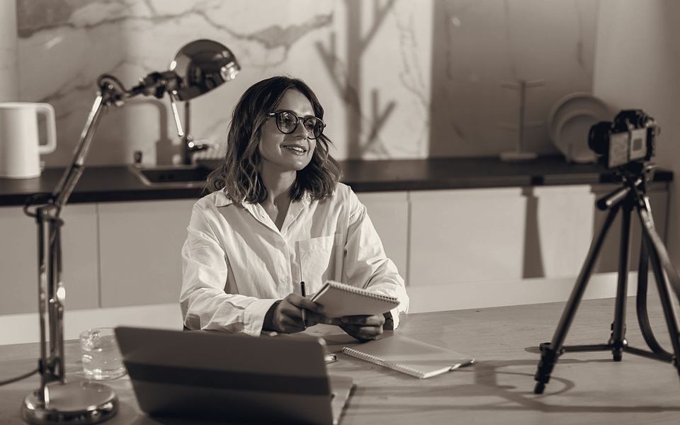 Content creator filming at her desk